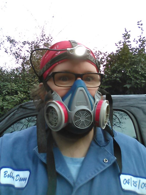 Robby in respirator for paint scraping